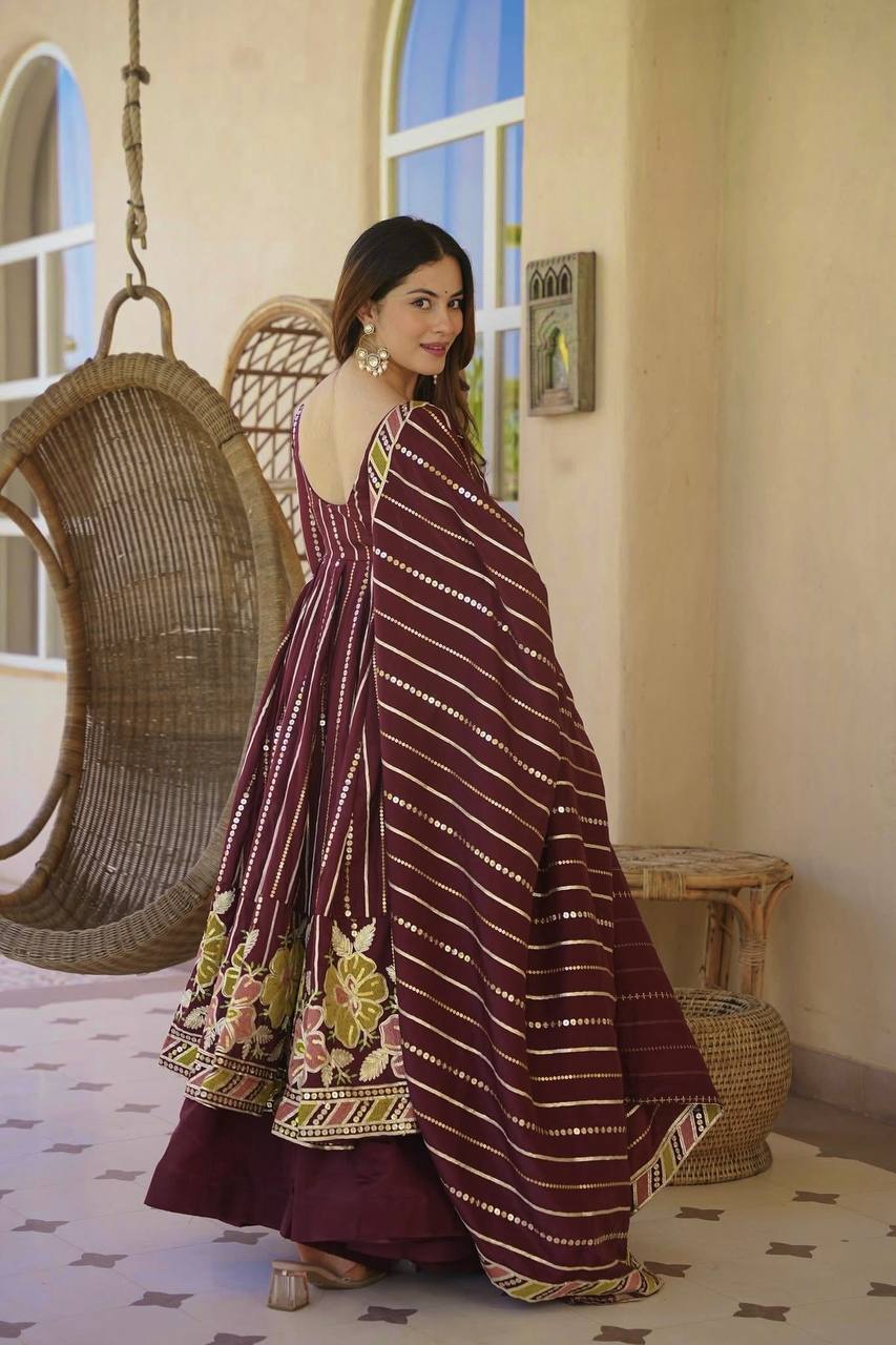 Majestic Maroon Flared Anarkali Suit Set Adorned with Luminous Sequin Stripes and an Ornate Floral Embroidered Hemline